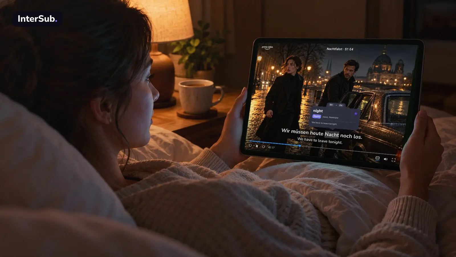 A woman in bed watches a German thriller on Prime Video on a tablet, with German and English subtitles; the InterSub dictionary shows “Nacht: night”