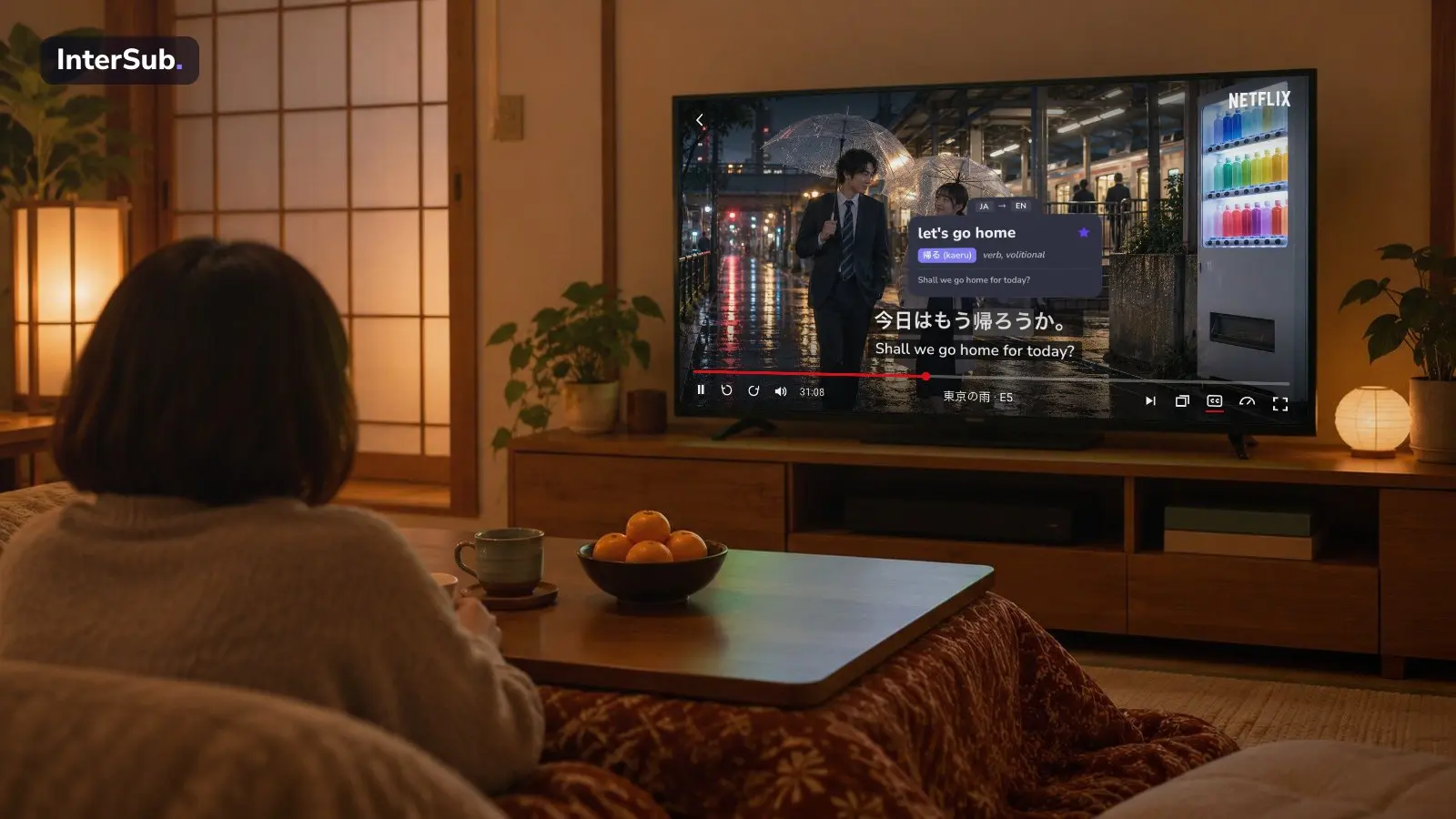 A person at a kotatsu table watches a Japanese drama on Netflix on the TV, with Japanese and English subtitles; the InterSub dictionary shows “帰ろう: let's go home”